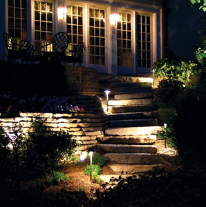 Multi-tiered landscape lighting installation up stone stairs